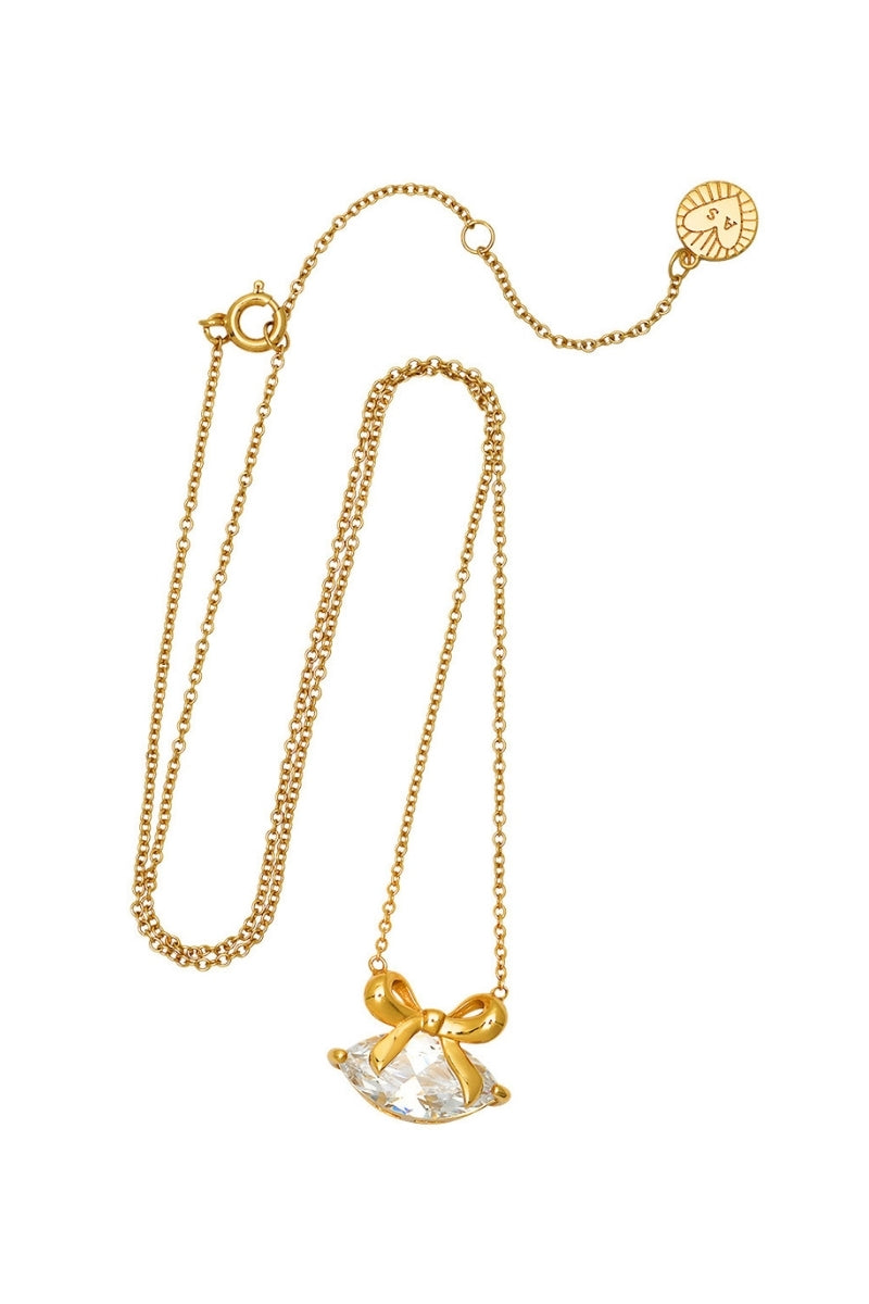 Gold Amelia Scott necklace with a bow pendant featuring clear cubic zirconia stones, elegant jewelry for special occasions.