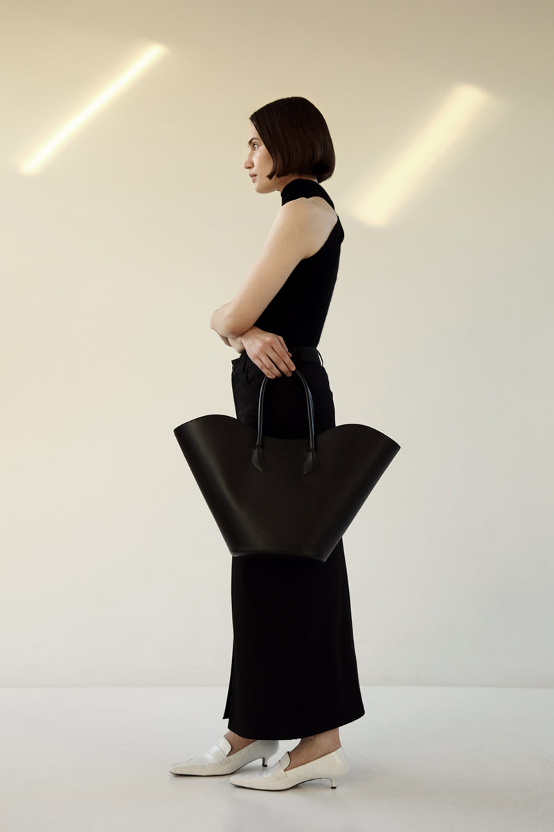 Black Willow shoulder handbag by ASK Scandinavia, featuring a sleek design with a top handle and spacious interior.