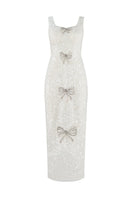 Ivory sequined scoop neck gown with bows by HACCHIC COUTURE, featuring elegant design and intricate detailing.
