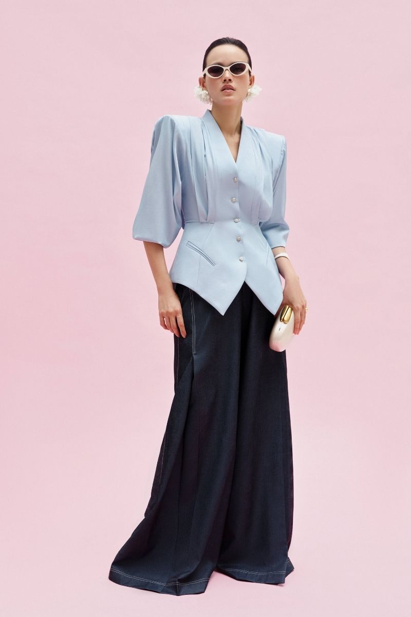 Jenny K Tran ATLAN PANTS I in blue denim, stylish casual pants with a relaxed fit, visible front pockets, and belt loops.