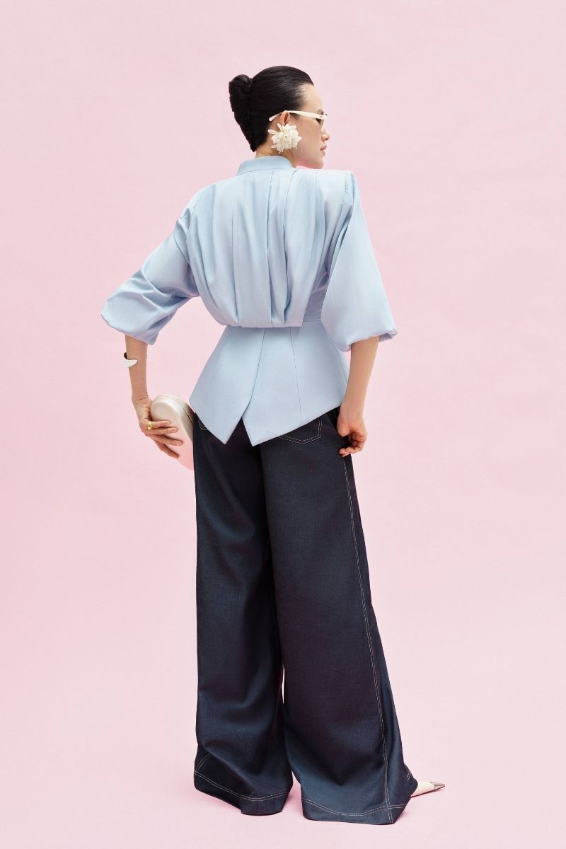 Jenny K Tran Atlan Pants in blue denim, slim-fit jeans with classic five-pocket design and stylish stitching.