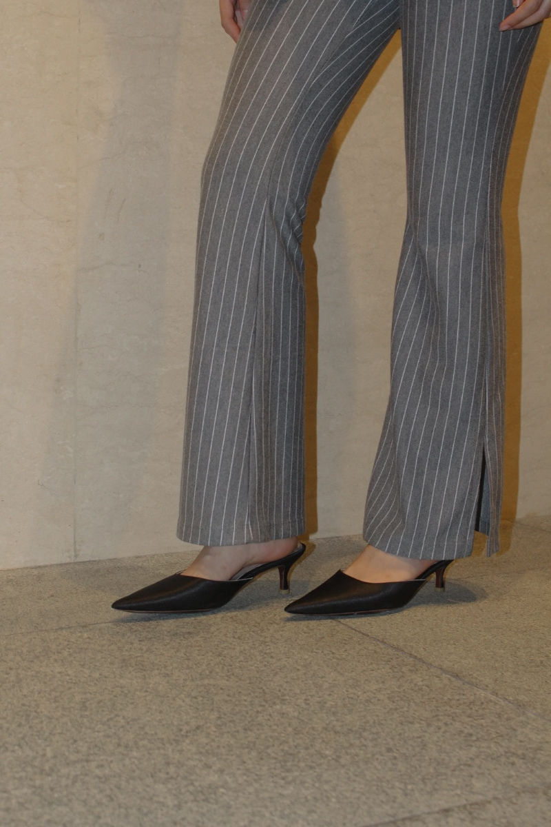 Black Christin Wu Audrey kitten heel shoes, stylish and elegant with pointed toes, shown in lifestyle imagery.