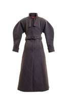 Blikvanger espresso brown puff-sleeved coat with tailored fit, shown in a stylish outdoor setting.