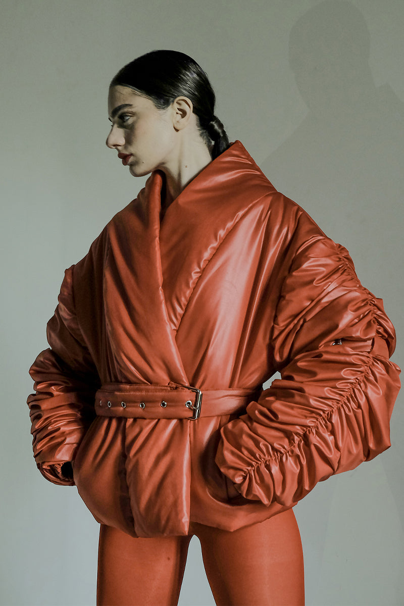 Red ruched sleeve puffer jacket by Blikvanger featuring a stylish, quilted design and a cozy, padded appearance.
