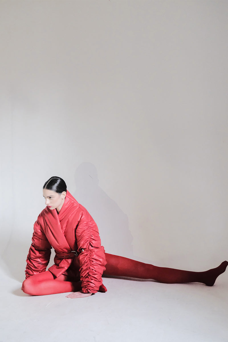Red ruched sleeve puffer jacket by Blikvanger, featuring a stylish design and padded insulation, perfect for cold weather.