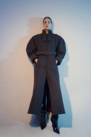 Blikvanger espresso brown coat with puffed sleeves, stylish and warm, shown on a model against a neutral background.