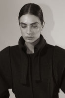 Blikvanger espresso brown puff-sleeved coat with a tailored fit, displayed on a hanger against a neutral background.