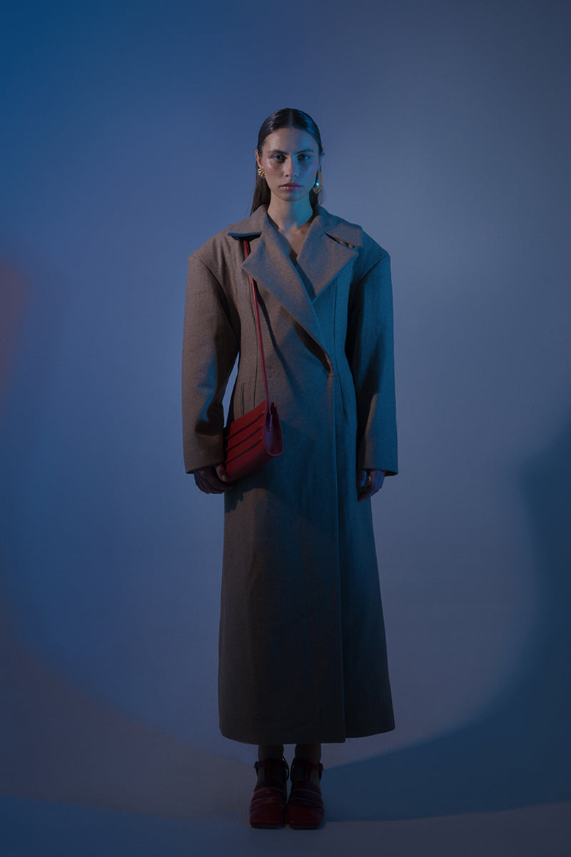 Long hazelnut beige coat by Blikvanger, shown on a hanger with front view and tailored details.