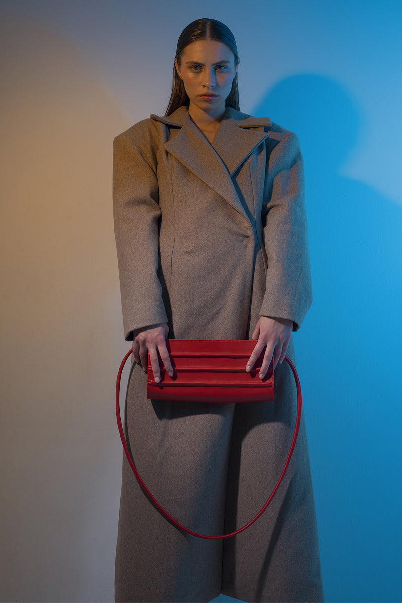 Long hazelnut beige coat by Blikvanger, featuring a classic tailored design and button details, perfect for fall and winter.