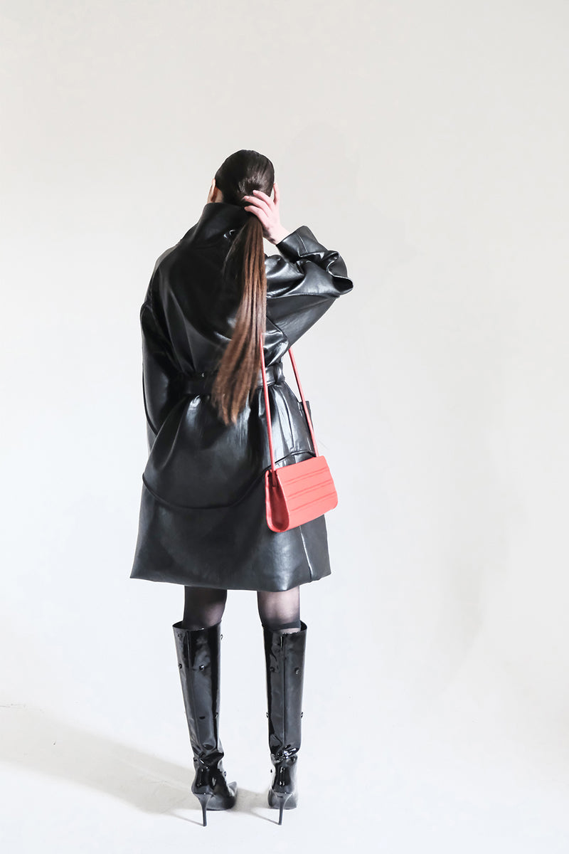 Black faux leather high-neck trench coat by Blikvanger with a sleek, stylish design and tailored fit.