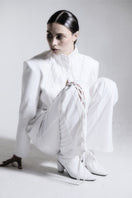 White high-neck pleated blazer by Blikvanger featuring structured design and elegant pleats, perfect for stylish formal wear.
