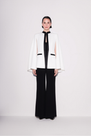 Lili Blanc black and white sleek cape blazer shown from the front, stylish tailored design perfect for formal or professional wear.