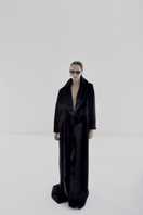Black vegan fur maxi coat by Lili Blanc, showcasing a luxurious, long coat with plush fur texture and elegant design.