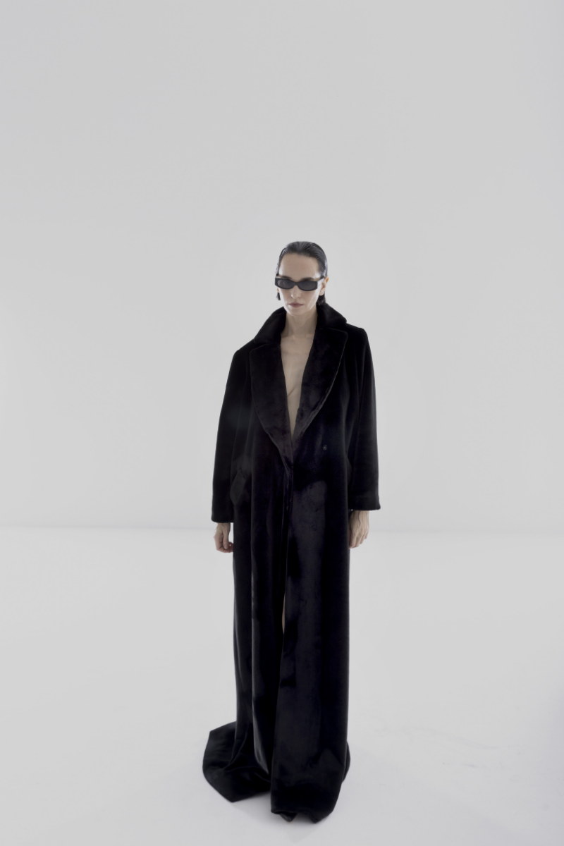 Black vegan fur maxi coat by Lili Blanc, showcasing a luxurious, long coat with plush fur texture and elegant design.