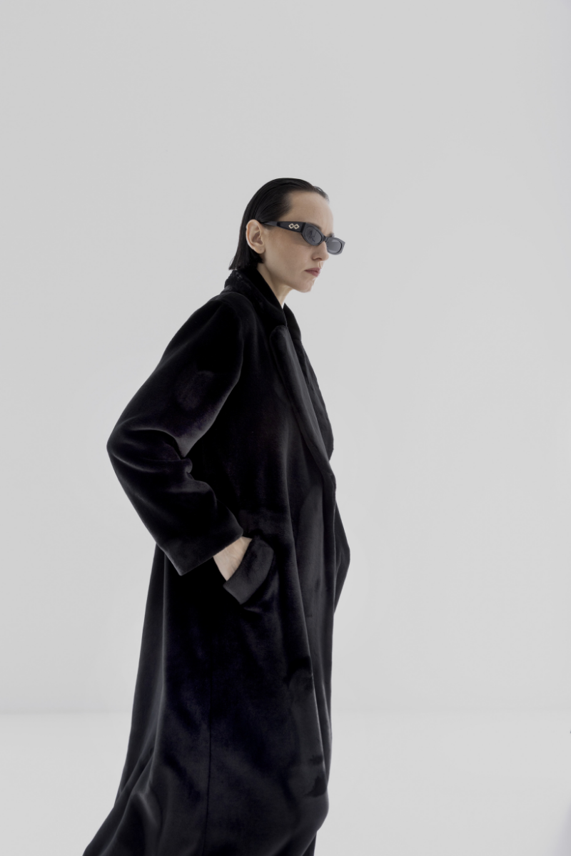 Black vegan fur maxi coat by Lili Blanc, stylish and luxurious winter outerwear with a plush, full-length design.
