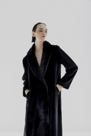 Black vegan fur maxi coat by Lili Blanc, showcased on a model with a stylish, luxurious look.