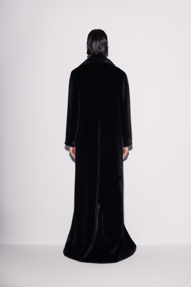 Black vegan fur maxi coat by Lili Blanc, shown from the back, featuring plush texture and long, elegant design.