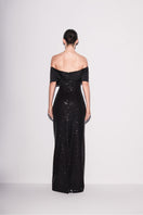 Lili Blanc black sequin off-shoulder gown with sparkling embellishments, shown from the back. Elegant evening wear for formal events.