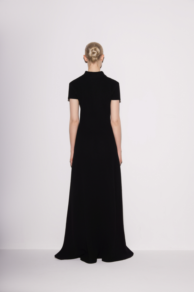 Black Lili Blanc classic knit A-line maxi dress shown from the back, featuring a flowing silhouette and soft knit fabric.
