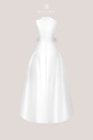 White pleated gown by HACCHIC COUTURE featuring elegant fabric and flowing design, displayed on a neutral background.