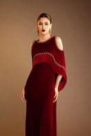 Red Valenciani shoulder cutouts cape gown showcasing a flowing design with dramatic shoulder details.
