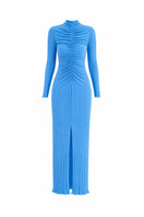 Maylé Vásquez Aborigen maxi dress in ice blue, flowing fabric with intricate patterns, styled for elegant summer wear.