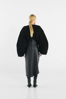 Black accordion snail sweater by MAZ Manuela Álvarez featuring a textured, layered design and long sleeves.