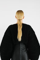Black accordion snail sweater by MAZ Manuela Álvarez, featuring textured, layered fabric design in a cozy, stylish sweater silhouette.