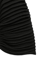 Black accordion snail sweater by MAZ Manuela Álvarez featuring a textured, ribbed design, shown on a model.