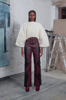 Maz Manuela Álvarez ivory accordion snail sweater displayed on a hanger with textured fabric and ribbed details.