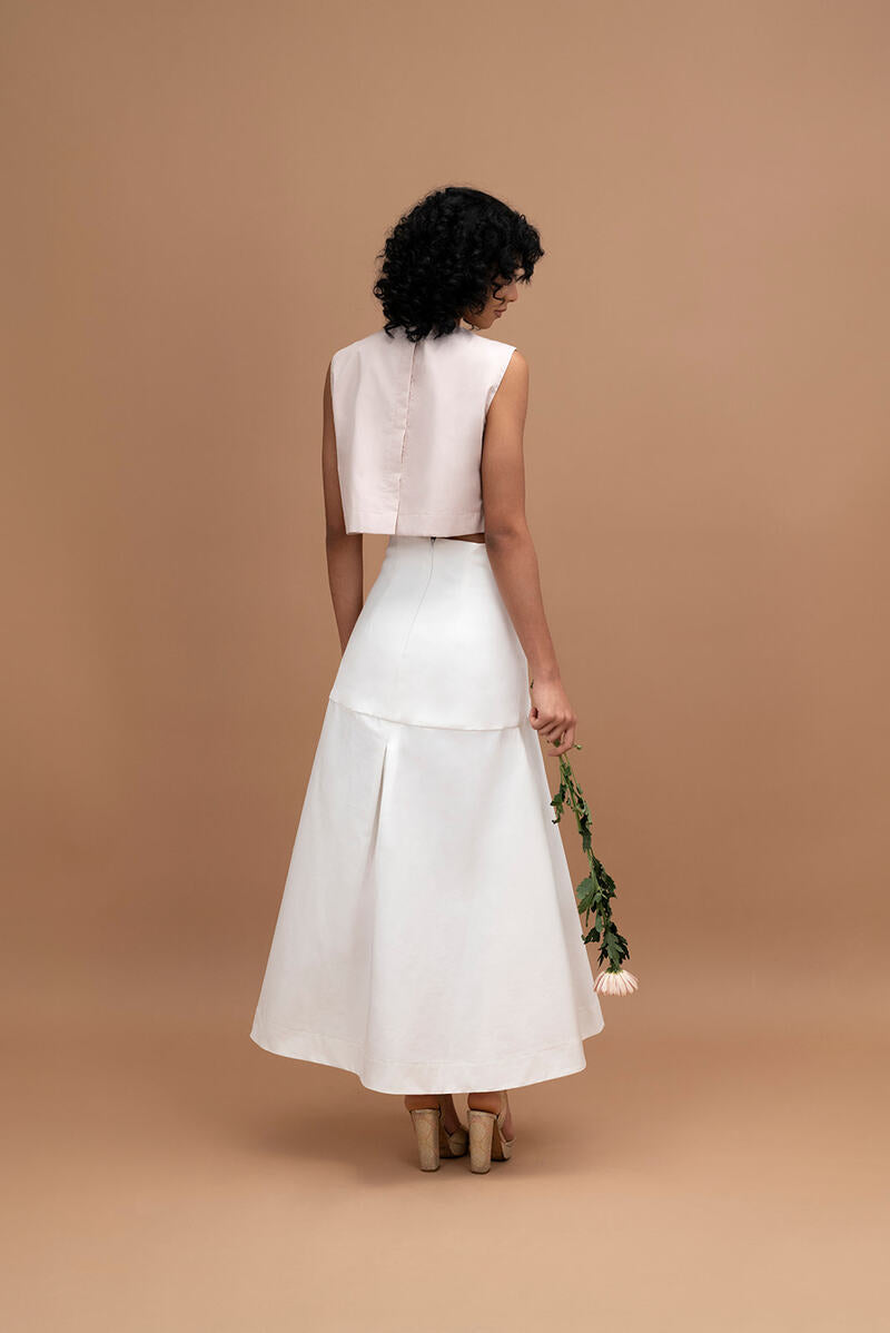 Ana + Maria ADA ivory midi skirt, flowing fabric and high waist, displayed on a model against a neutral background.