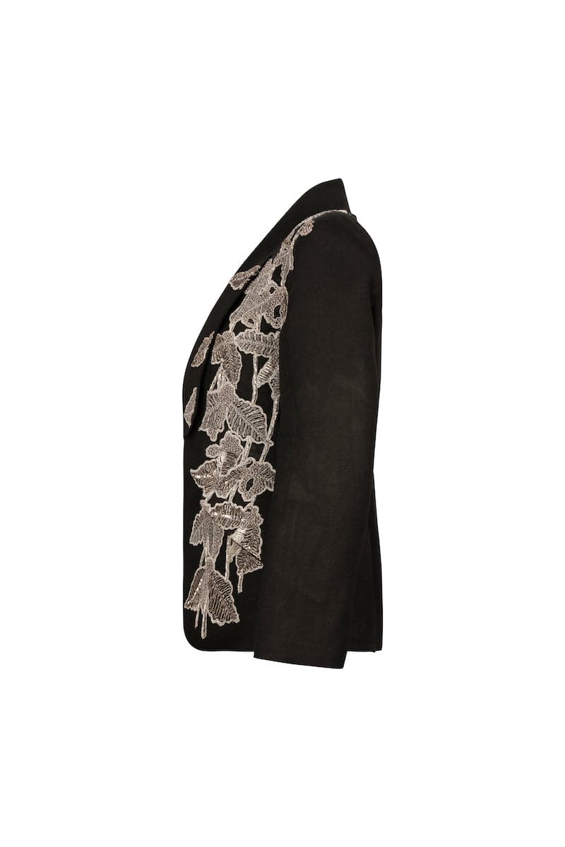Black beaded blazer by Nadya Shah displayed on a mannequin, showcasing intricate beading and tailored fit.