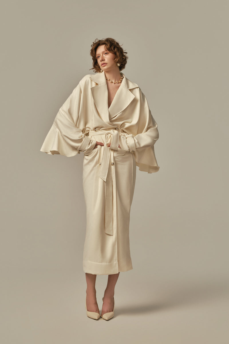 White AILE coat by POEM displayed on a model, showcasing a stylish, modern coat with clean lines and a sophisticated design.
