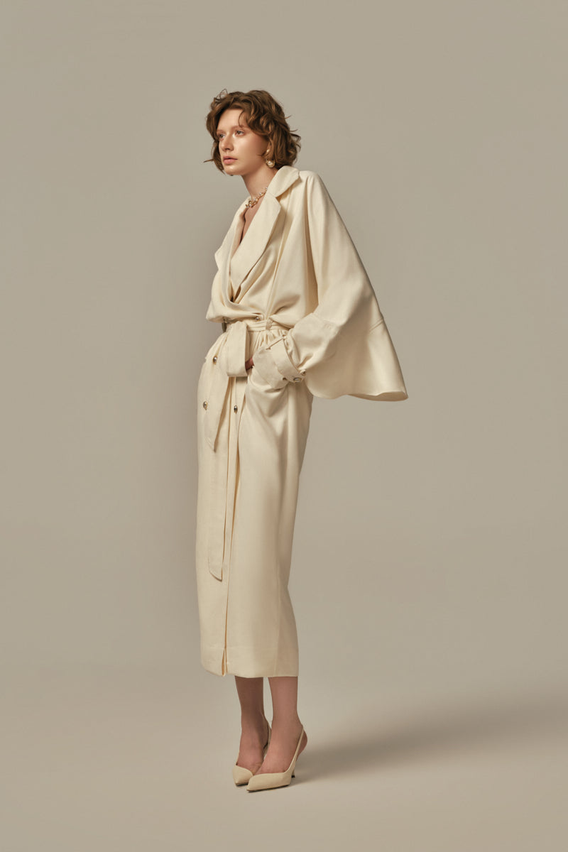 White POEM AILE coat shown on a model, featuring a sleek design and modern silhouette for stylish winter wear.