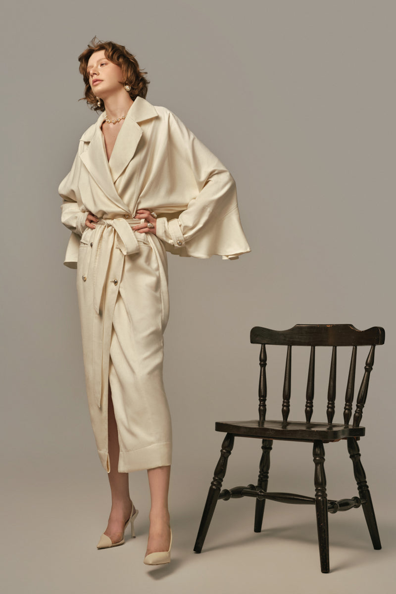 White AILE coat by POEM, stylish and cozy outerwear with a sleek design, shown on a model.