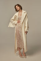 White AILE coat by POEM, stylish outerwear featuring a sleek design and tailored fit, shown on a model.