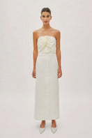 Labeca Alaia white linen twist maxi dress showing a flowing, elegant design with a twist detail at the waist on a model.