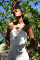 Off-white Alana bustier top by ANA + MARIA, featuring structured design and adjustable straps, shown on a hanger.