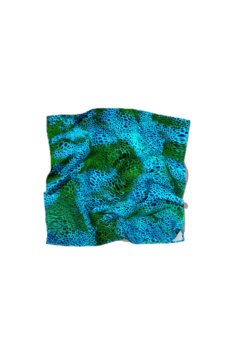 Amel Batita Alga Moussard silk scarf featuring a vibrant, abstract blue and yellow pattern on lightweight fabric.
