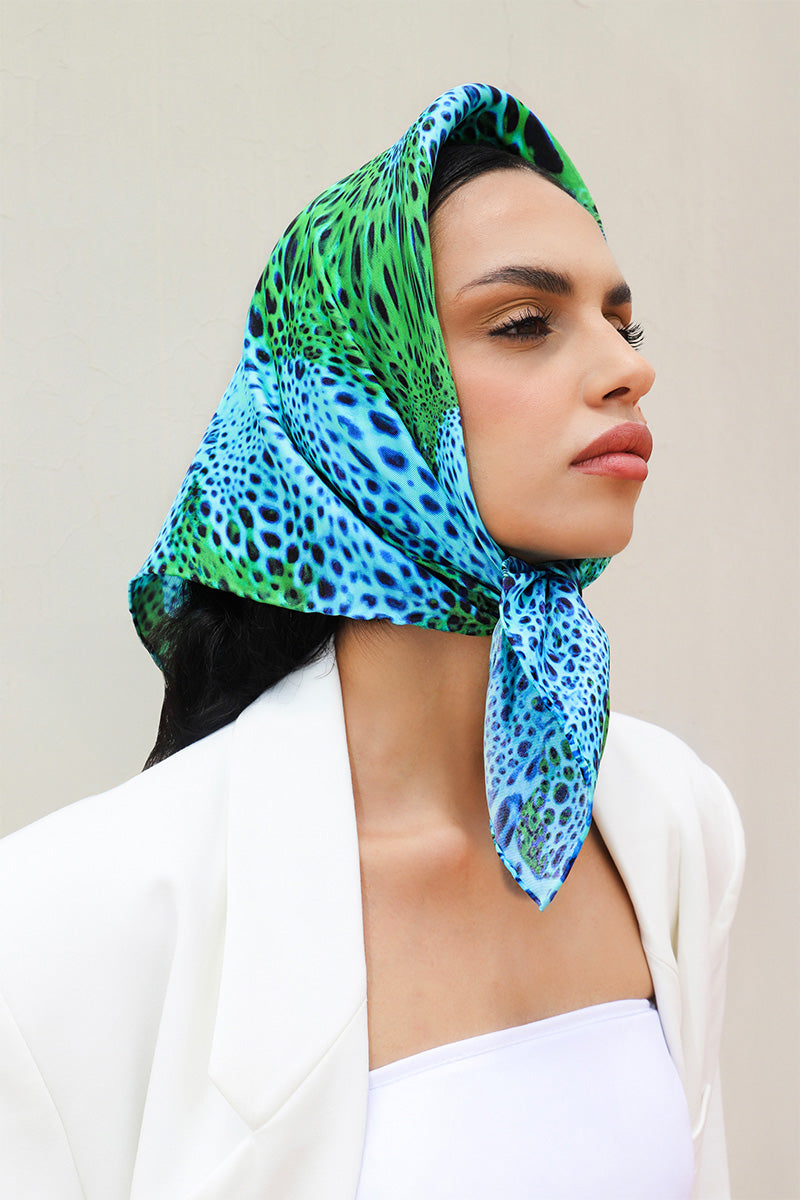 Silk alga moussard scarf by Amel Batita featuring vibrant blue and yellow abstract floral pattern, styled as a headscarf.