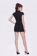 Black Nana Jacqueline Alina mini skirt displayed on a model, featuring a sleek, straight design perfect for stylish casual wear.