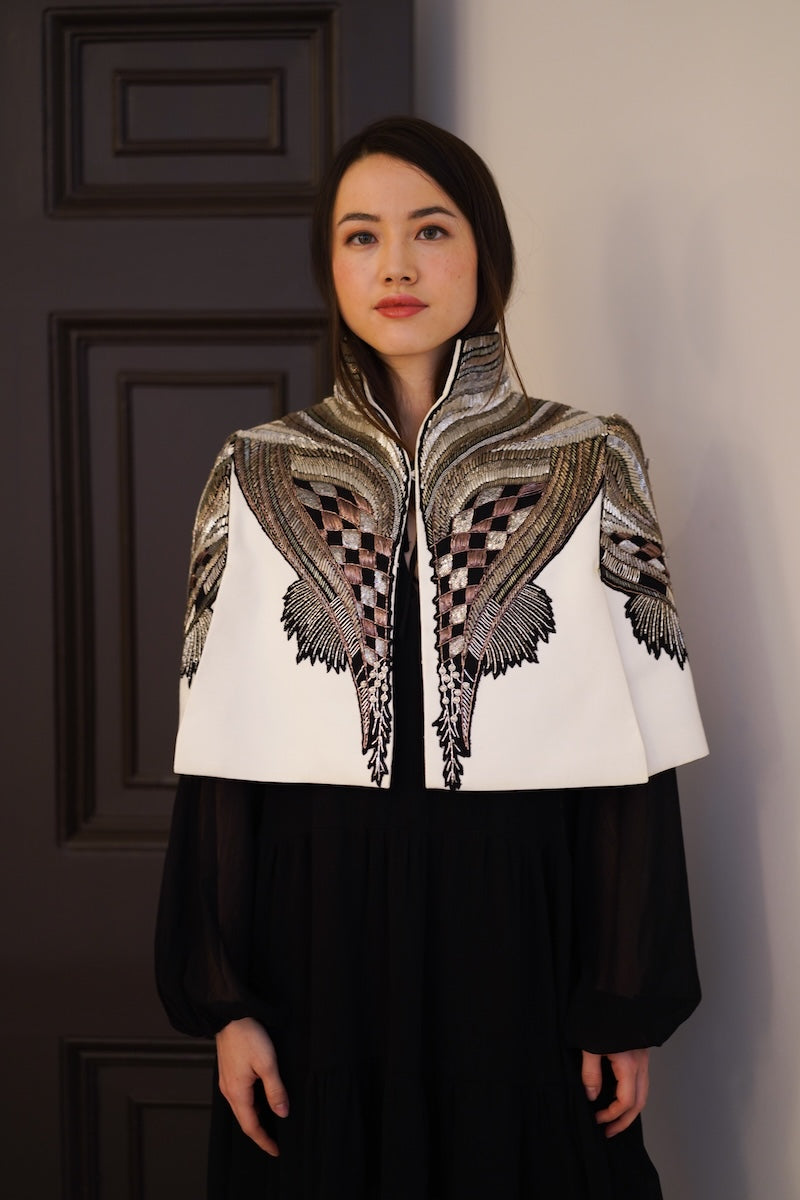 Nadya Shah All About Eve ivory capelet jacket with soft fabric and stylish design, displayed on a neutral background.