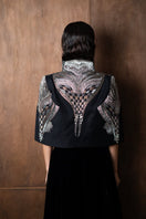 Nadya Shah All About Eve cape jacket with elegant draped design and textured fabric, styled for a sophisticated look.