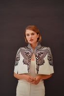 Ivory All About Eve capelet jacket by Nadya Shah, featuring elegant draped design and soft fabric, ideal for layering and stylish wear.