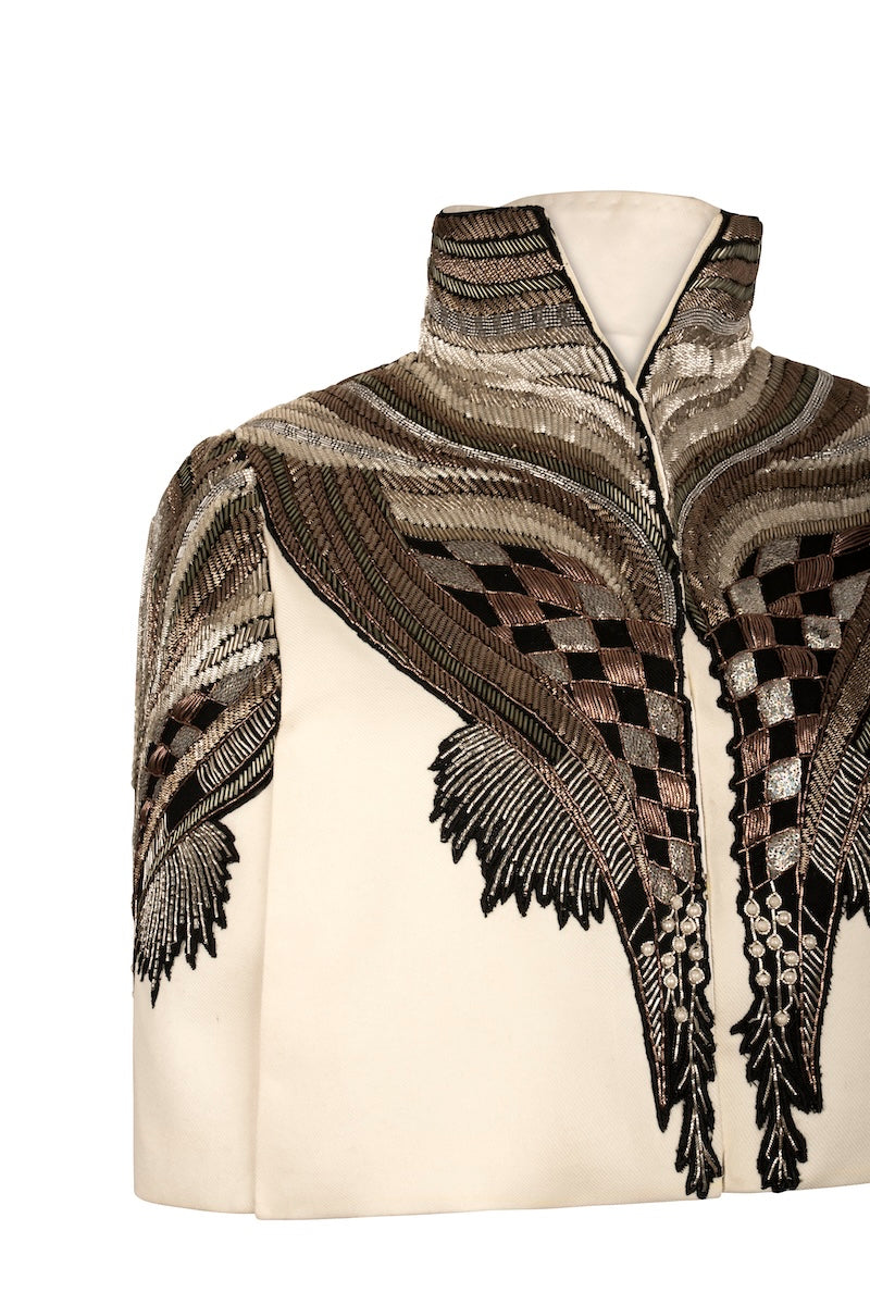 Nadya Shah All About Eve ivory capelet jacket displayed on a mannequin, showcasing elegant, lightweight outerwear.