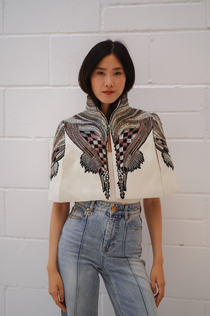 Ivory All About Eve capelet jacket by Nadya Shah, featuring a stylish, elegant design with soft fabric and detailed craftsmanship.