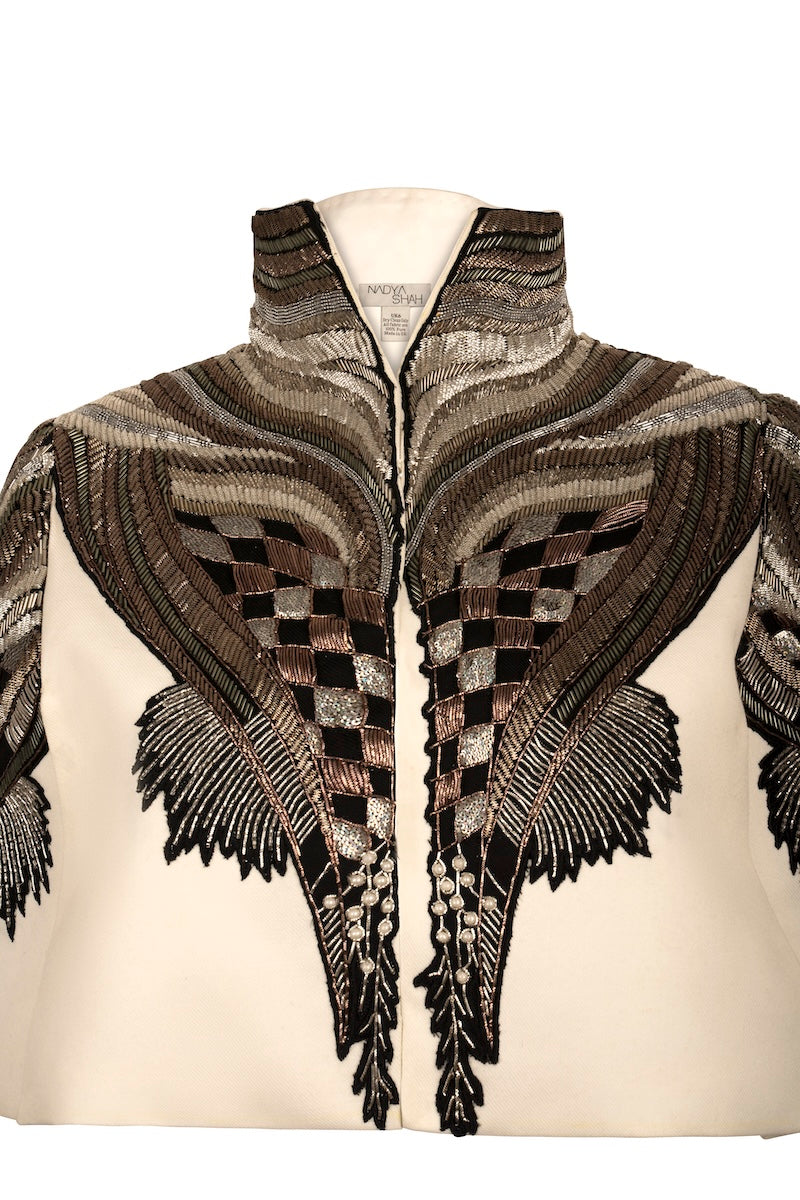 Nadya Shah All About Eve ivory capelet jacket with detailed embroidery and elegant design, perfect for layering.