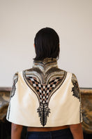 Ivory Nadya Shah All About Eve capelet jacket with a flowing, elegant design, shown from the back.