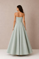 Green Aloe dress gown by Nihan Peker, flowing fabric with elegant design, showcased on a model.