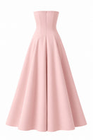 Light pink Aloe dress gown by Nihan Peker, flowing fabric with elegant design, displayed on a hanger.